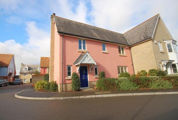 Pink house on a corner of new build estate