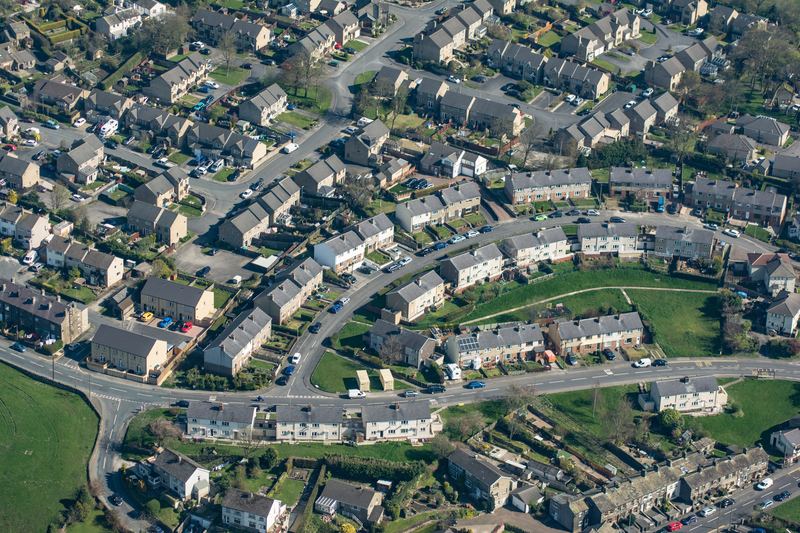 Sky view of a collection of houses in a village.