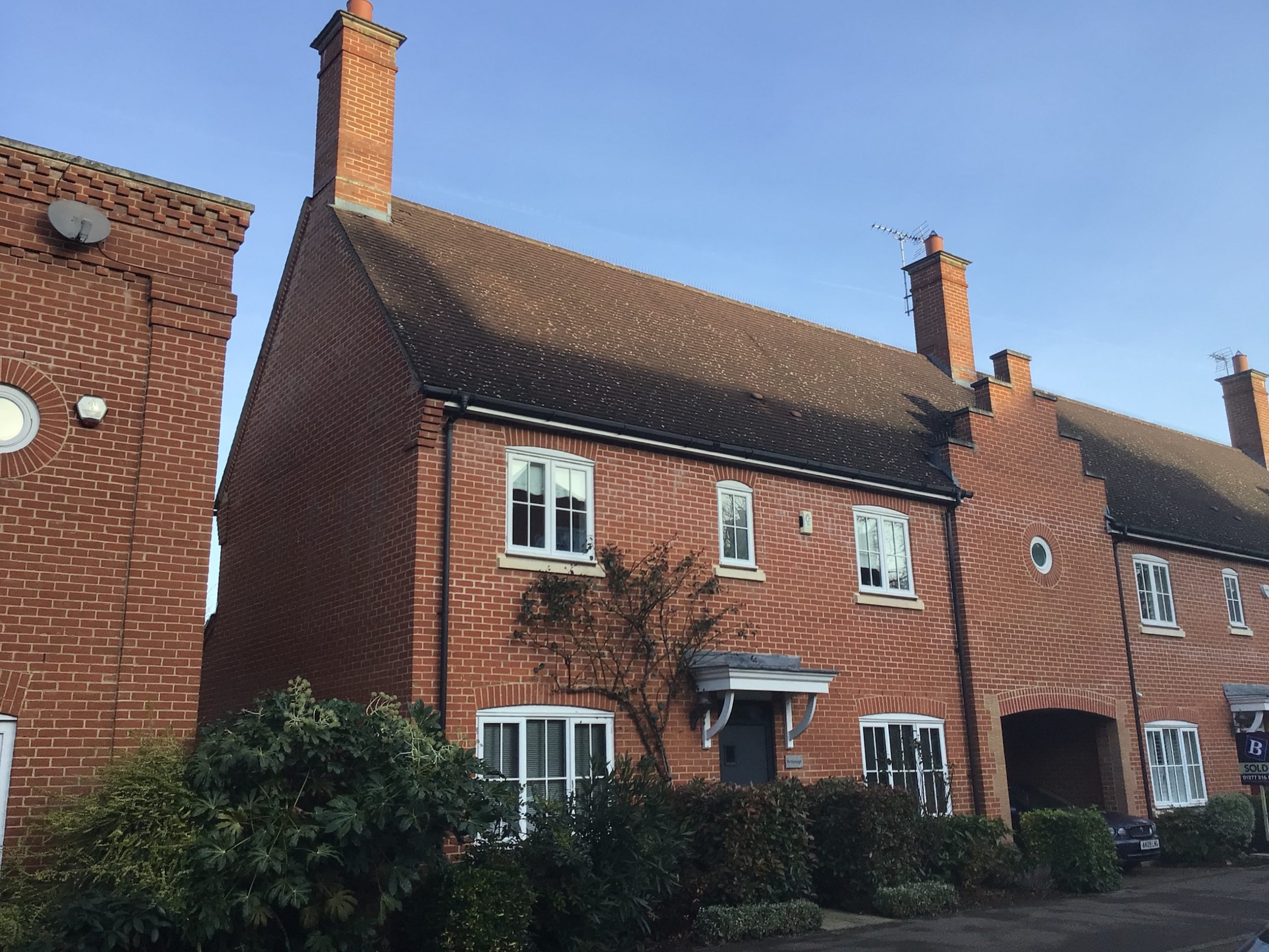 exterior view of a house with bushes in front